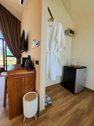 a room with a white robe hanging on a wall at The field@pua เดอะฟิลด์แอทปัว in Pua