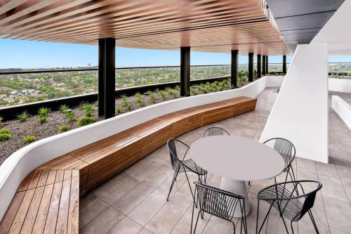 a balcony with a table and chairs and a view at Chic 1BR1B w BBQ, GYM, walk to Box Hill Central in Box Hill