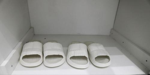 a white drawer with four rolls of toilet paper at Апартаменты в ЖК Каркын in Kostanay
