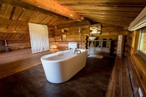 a large bath tub in a room with wooden walls at Casa Laricciu in Figari