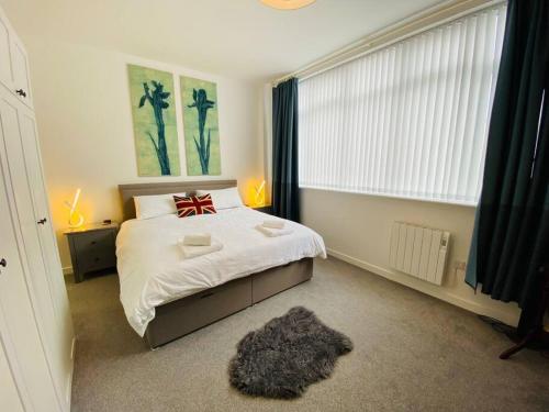 a bedroom with a bed with a red bow on it at Portland View - Spacious & Comfortable in Weston