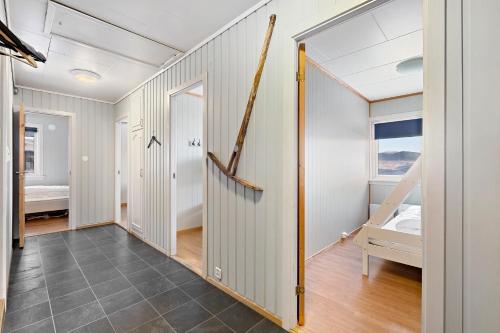 a hallway with white walls and a staircase in a house at Voss Resort self-service apartments in Skulestadmo