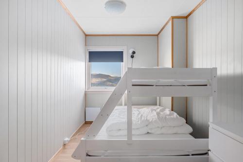 a white bunk bed in a room with a window at Voss Resort self-service apartments in Skulestadmo