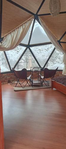 two chairs in a room with a large window at Glamping Town in Otinapa