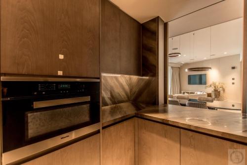 a kitchen with wooden cabinets and a stove at Super Spacious 3BR with Maid's Room in Five Palm in Dubai
