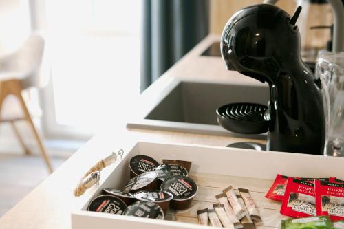 a black mixer sitting on a counter next to a sink at 8th Hill Apartments in Plovdiv