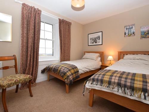 a bedroom with two beds and a window at 5 bed in Chirnside 77337 in Duns