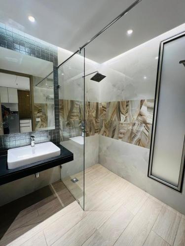 a bathroom with a sink and a mirror at Luxe jacuzzi studio key 2 in Gurgaon