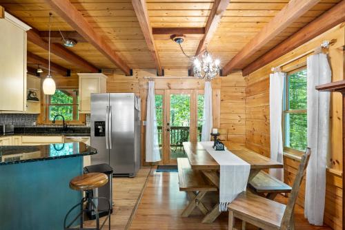 a kitchen with a table and a refrigerator at Antlers Crossing in McGaheysville