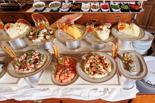 a table topped with plates of food and desserts at Pirin Golf & Country Club Apartment Complex in Bansko