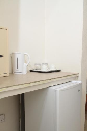 a kitchen counter with a plate and a coffee mug at Spring Hotel Bequia in Port Elizabeth