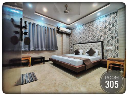 a bedroom with a bed in a room at Shri Ganga View Guest House in Rishīkesh