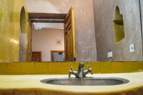 a sink with a faucet in a room at Bab Atlantique in Essaouira