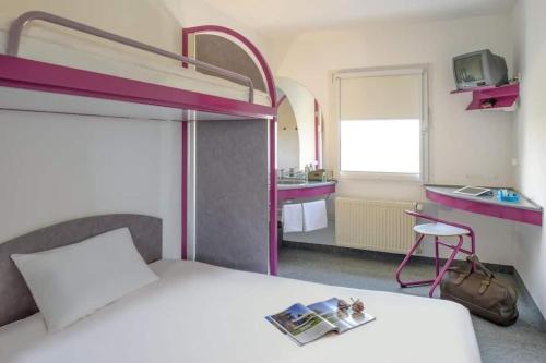 a bedroom with a bunk bed and a bathroom at PRIMOTEL in Schkeuditz