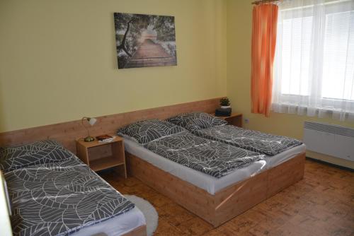 a bedroom with two twin beds and a window at Chata Bystřička in Velká Lhota