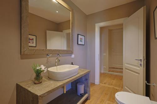a bathroom with a sink and a mirror at Gio Toscana in Castiglione della Pescaia