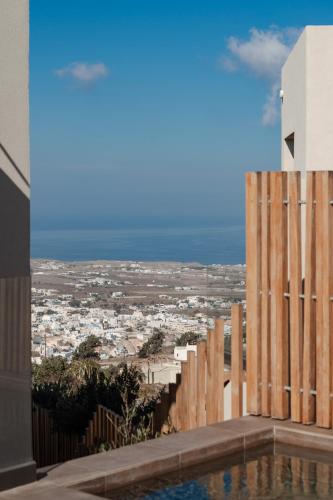 a view of the city from the balcony of a building at Apikia Santorini in Pirgos