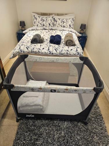 a bed frame with two pairs of shoes on it at Your Own Ground Floor Apartment in Central Woking in Woking