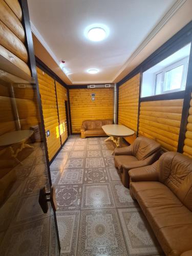 a room with a couch and a table in it at MishyN-City Hotel in Dobrovlyany