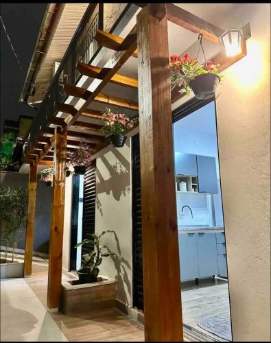 a wooden stairway with potted plants on it at Espaço da Zilda in São José