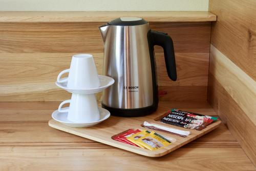 a coffeemaker and a coffee pot on a shelf at Hotel Apostolite in Sandanski