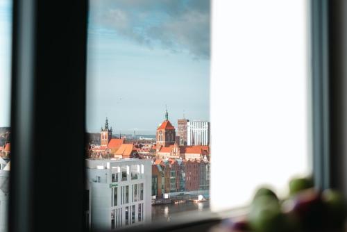 a view of a city from a window at Hotel Marina Club Old Town View in Gdańsk
