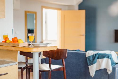 a kitchen with a table with oranges and drinks on it at Hotel Marina Club Old Town View in Gdańsk