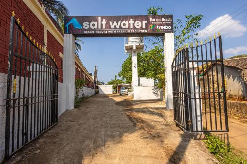a gate with a sign that reads salt water next to a building at Treebo Trend Salt Water Beach Resort in Dapoli