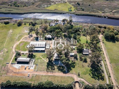 an aerial view of an old mansion with a lake at Rivergate Guest Farm in Stanford