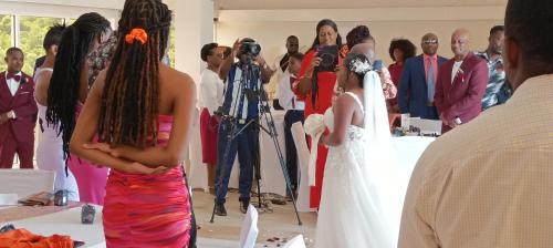 a bride and groom standing in front of a camera at Spring Hotel Bequia in Port Elizabeth