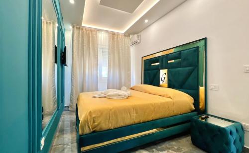 a bedroom with a yellow bed and a mirror at Serenity Suite in Montecatini Terme