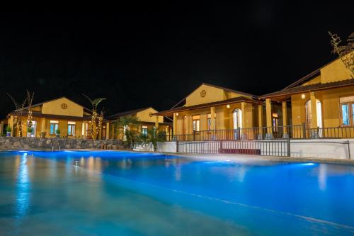 a swimming pool in front of houses at night at Sky Bay Ha Giang in Ha Giang