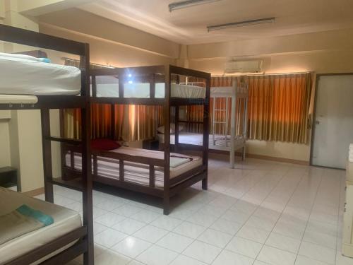 a room with three bunk beds in a dorm at Cat Home in Hat Yai