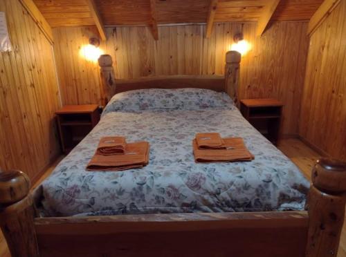ein Schlafzimmer mit einem Bett mit zwei Handtüchern darauf in der Unterkunft Dino's Ranch in Villa El Chocón