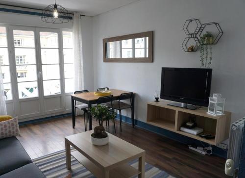 a living room with a couch and a tv at 3 Bedrooms - Spacious and friendly - City Center in Caen