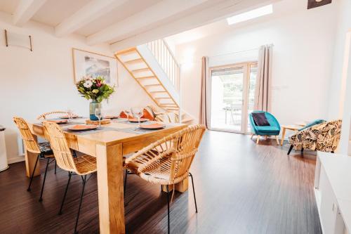 une salle à manger avec une table et des chaises en bois dans l'établissement Chalets et gîtes d'Orlu, à Orlu