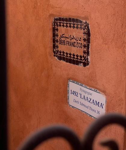 a sign on the side of a building with a sign on it at RIAD DAR NAOMI in Marrakech