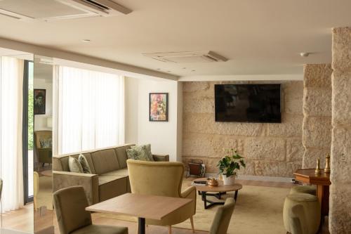 a living room with a couch and a table at Ribeira House in Mirandela