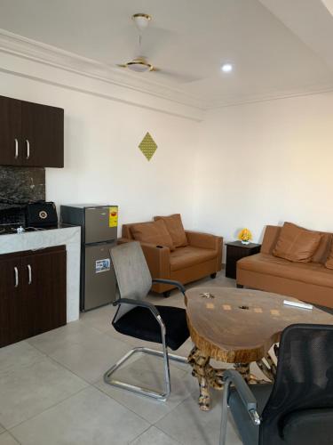 a living room with a couch and a table at CRL Apartment 1 in Tema
