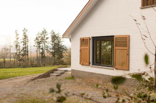 a house with a window on the side of it at Gîte de Brohimont Vakantiehuis - Cottage - Exclusive Home of Silence - All in in Houyet