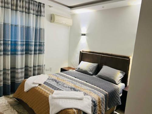 a bedroom with a bed with towels on it at Amazing Apartment Overlooking CityStars in Cairo