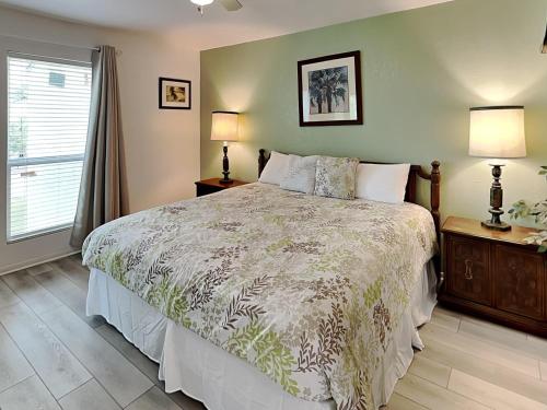 a bedroom with a bed and two lamps and a window at A Bay From It All in Rockport