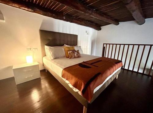 ナポリにあるCasa Donnareginaのベッドルーム1室(ベッド1台、ナイトスタンド、ランプ付)