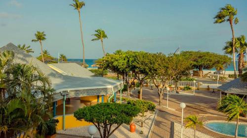 a view of a resort with a pool and palm trees at MVC Eagle Beach in Palm-Eagle Beach