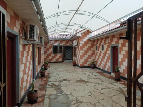 an empty courtyard of a building with potted plants at Hotel Double N - Kisumu in Kisumu