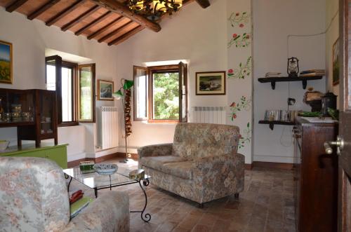 サン・セヴェリーノ・マルケにあるAgriturismo Villa Rosettaのリビングルーム(ソファ、椅子付)