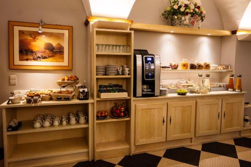 a coffee shop with a coffee machine in a room at Cit'Hotel Sphinx - Hotel in Montélimar