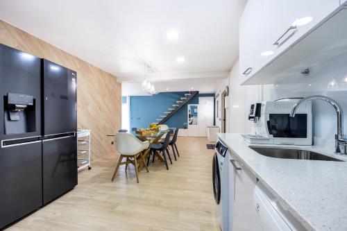 a kitchen with a black refrigerator and a table at Altura Dreams in Altura