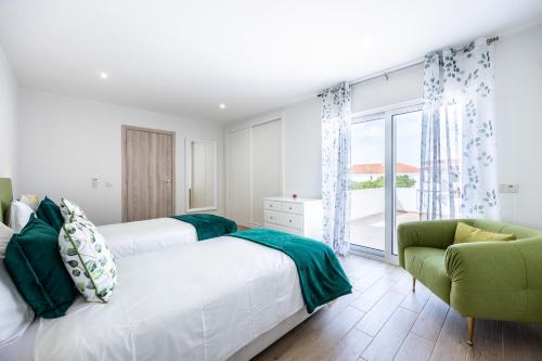 En eller flere senge i et værelse på Altura Dreams