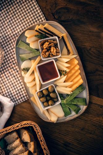 a plate of cheese and other foods on a table at Penzion Pivnice - Jítravský Dvorec in Rynoltice